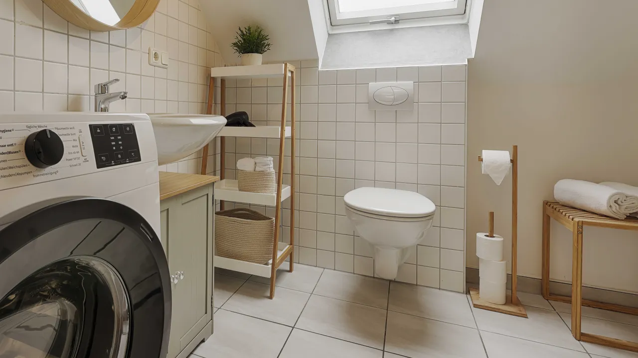 The bathroom is fitted with a washing machine. 